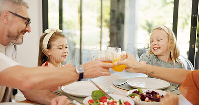 Buy stock photo Cheers, lunch and parents with children in home for brunch, dinner or meal together for bonding. Family, happy and mom, dad and kids at dining table toast with drink for wellness, health or nutrition