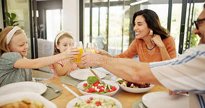 Buy stock photo Cheers, parents and girls with food, celebration and healthy meal with happiness, home and orange juice. Family, father or mother with daughters, lunch or support with love, smile or bonding together