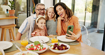 Buy stock photo Selfie, happy and family at dining table for lunch in home together with memory, bonding or connection. Photography, food and parents with girl children for profile picture with healthy meal in house