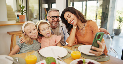 Buy stock photo Selfie, goofy and family at dining table for lunch in home together with memory, bonding or connection. Photography, food and parents with girl children for profile picture with healthy meal in house