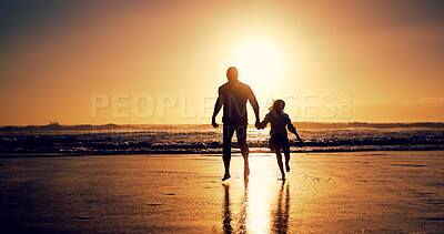 Buy stock photo Ocean, sunset and father with girl, holding hands and travel with happiness, bonding together and wellness. Nature, beach and family with parent, daughter and dad with summer holiday and silhouette