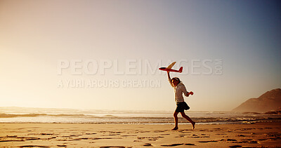 Buy stock photo Child, beach and playing with airplane toy for flying game, sunset fun or imagination travel on holiday. Mockup space, girl kid and running at ocean with fantasy flight, vacation freedom or adventure