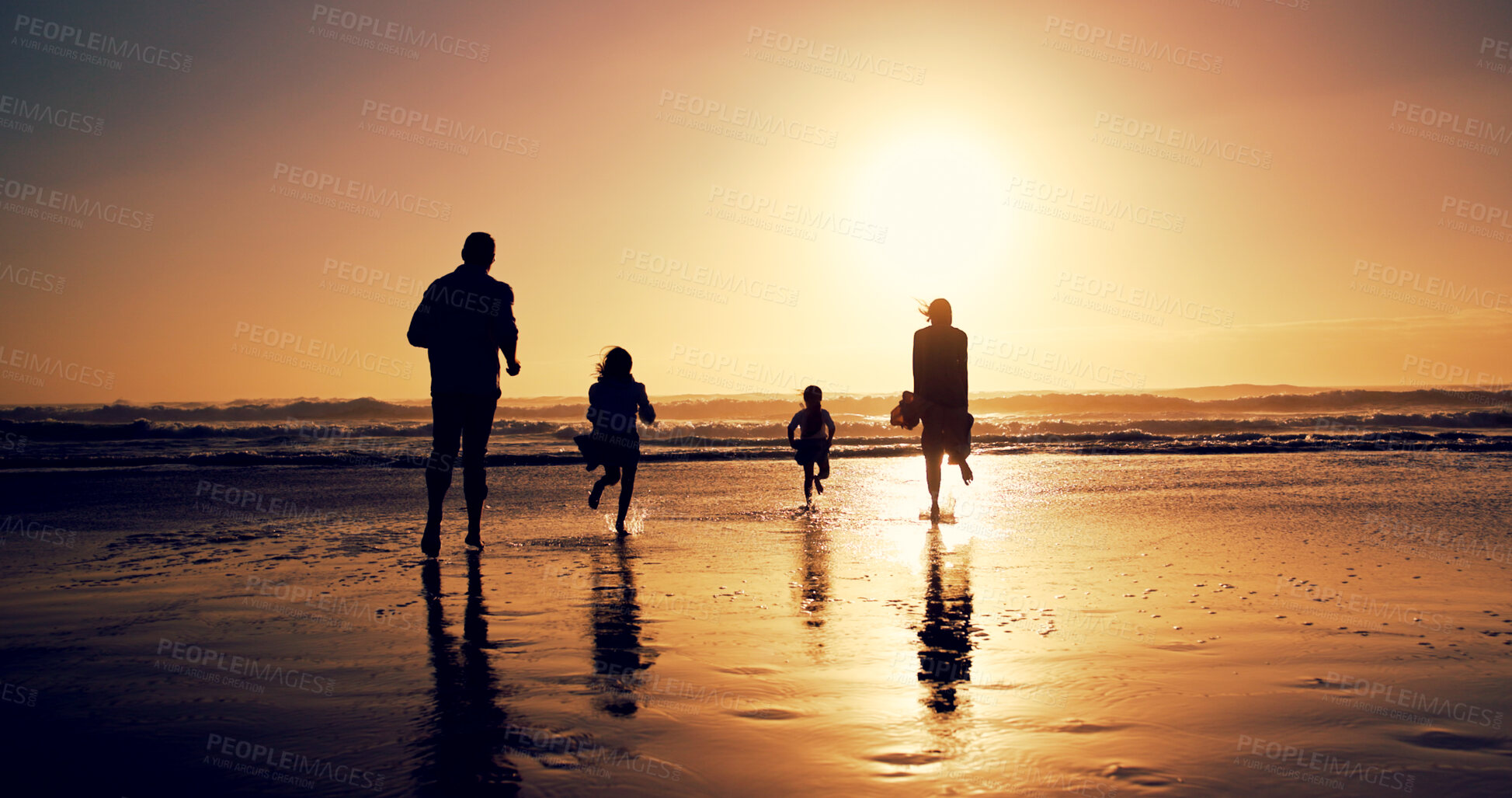 Buy stock photo Sunset, family and running in sea water for holiday, bonding or energy with back outdoor. Race, mother and father with kids at beach with space, travel or play game with parents on summer adventure