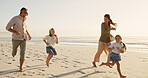 Running, family and playing on holiday at beach for vacation, space or laugh together outdoor. Race, mother and father with children at ocean for travel, summer adventure or game with happy parents