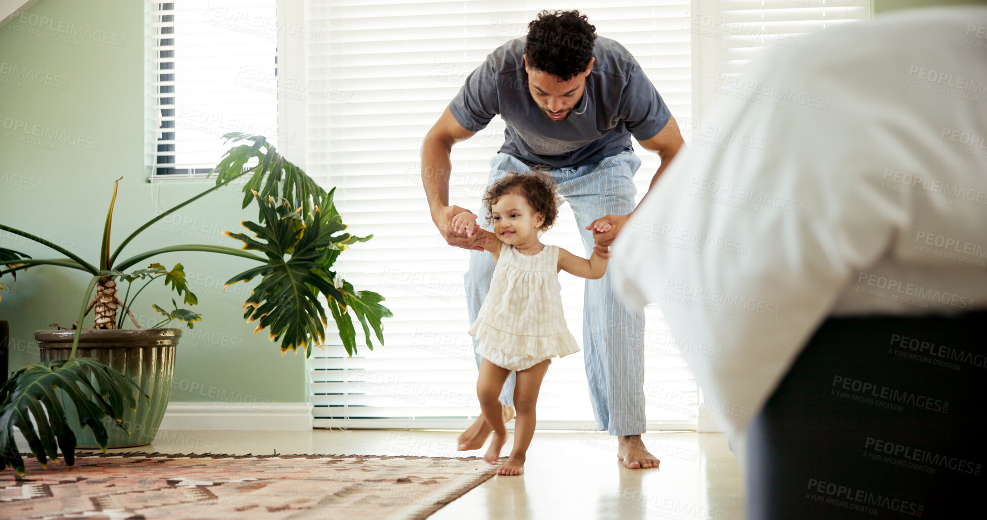 Buy stock photo Dad, toddler or learning to walk in home with holding hands, first steps or helping with balance. Happy family, child or man with teaching coordination in bedroom with mobility support or development