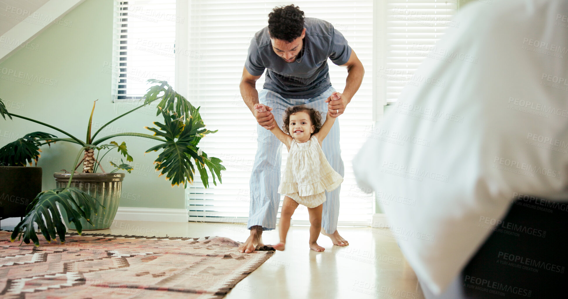 Buy stock photo Father, child and learning to walk in home with holding hands, first steps and support with mobility. Happy family, toddler and man with teaching balance in bedroom for practice or growth development