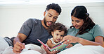 Reading, book and parents with baby in bed at home together for bonding in morning on weekend. Happy, love and girl toddler relaxing with mother and father for storytelling in bedroom at house.