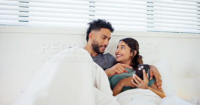 Buy stock photo Talking, phone and couple in bed in morning for social media, online website and internet in home. Happy, wake up and man and woman on smartphone for relaxing, bonding and relationship on weekend
