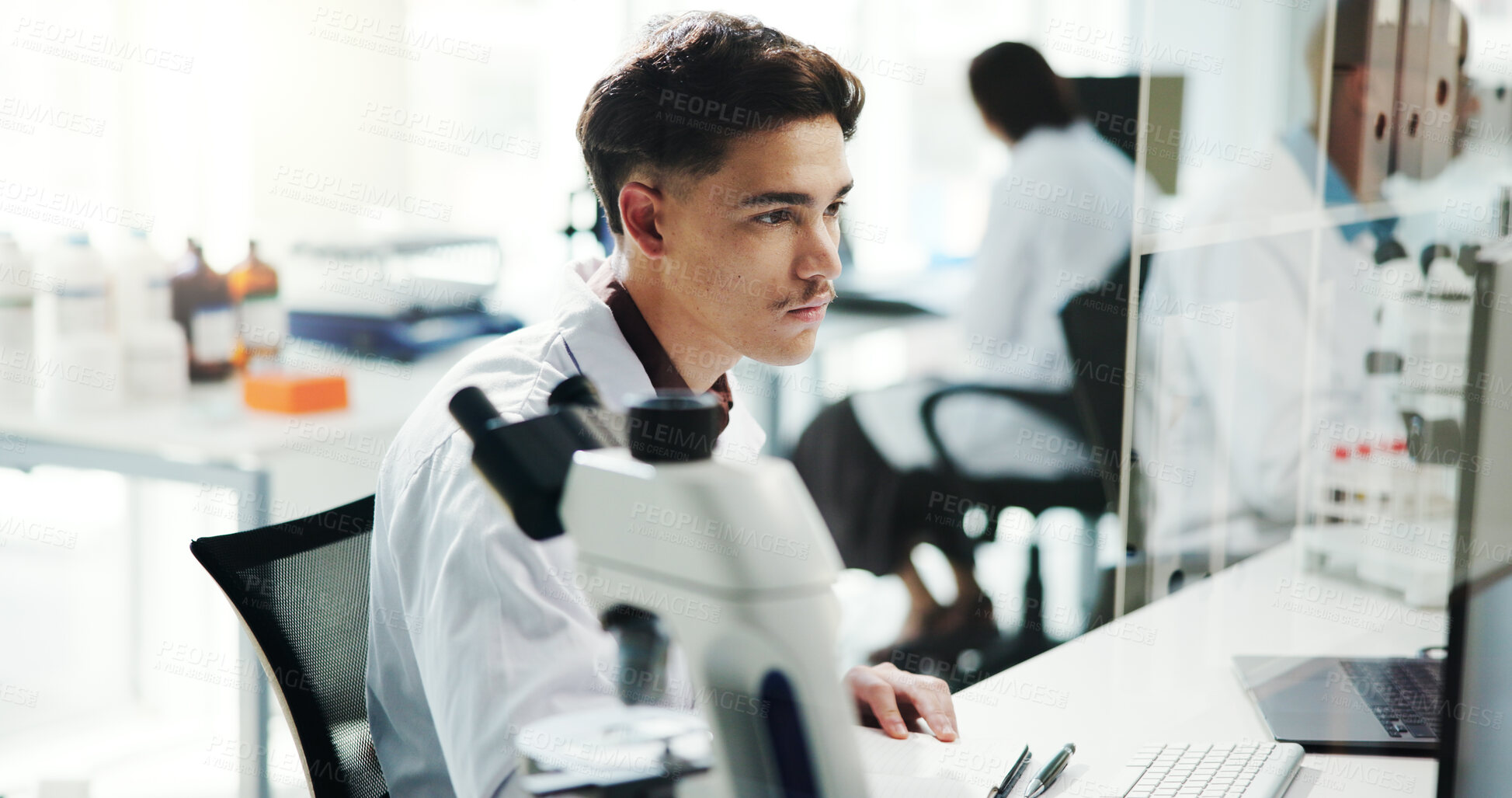 Buy stock photo Man, scientist and check on computer in lab of medical research, experiment and information. Person, microscope and online of healthcare report, biotech and investigation feedback of vaccine solution