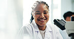 Portrait, black woman and scientist with microscope in lab for medical research, experiment and about us. Smile, person and biotechnology, studying virus and sample testing for pharmaceutical vaccine