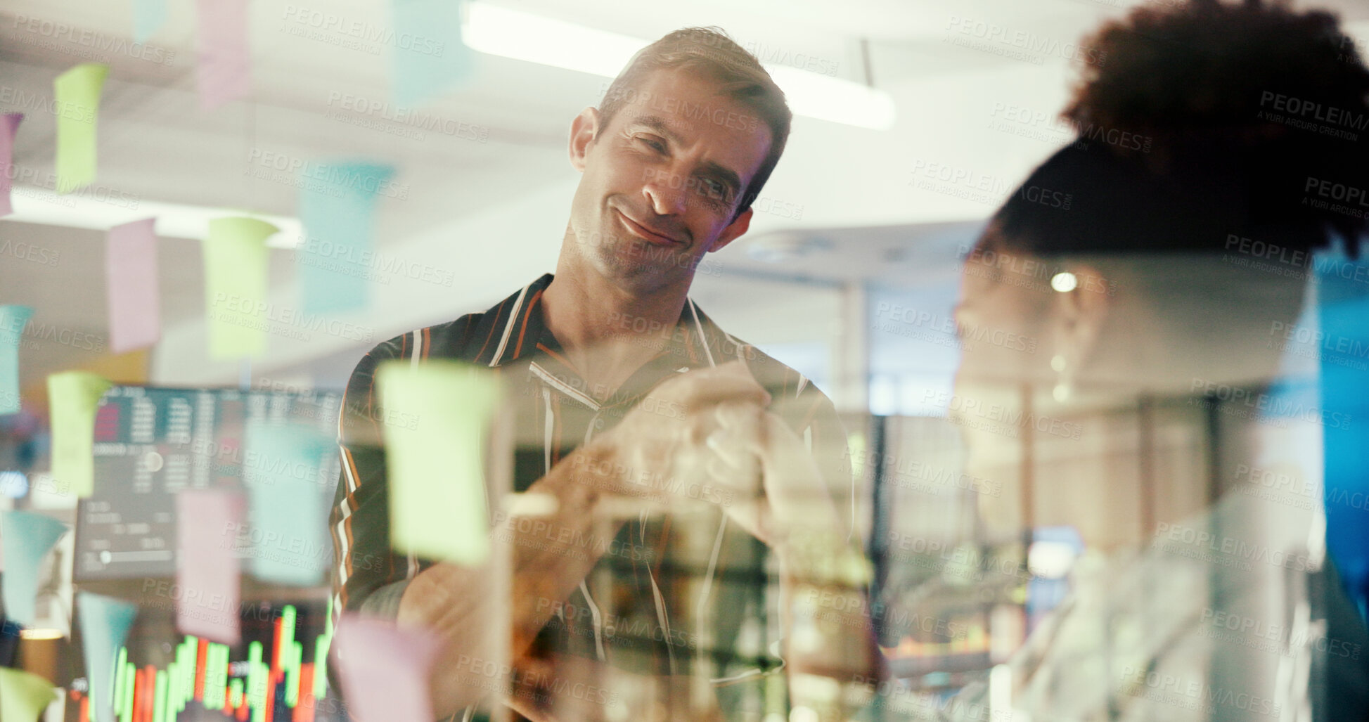Buy stock photo Man, woman and fist bump with notes at office by glass wall, planning and happy with support for solution at startup. People, celebration and motivation with project management, goals and partnership