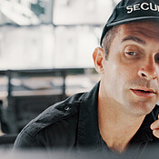Security, computer and man with radio, surveillance and communication ...