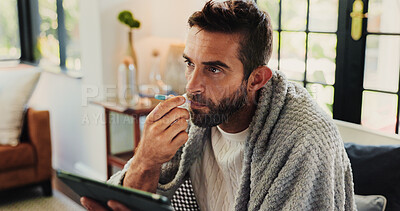 Buy stock photo Tablet, man and sick with thermometer in home, check fever and influenza with research for symptoms. Sofa, male person and illness with temperature for flu, consultation and telehealth with digital