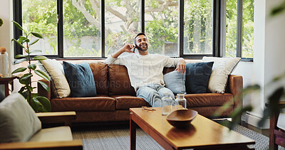 Buy stock photo Phone call, relax and smile with man on sofa in living room of home for break, satisfaction or wellness. Conversation, thinking and time off with happy person in apartment for morning communication