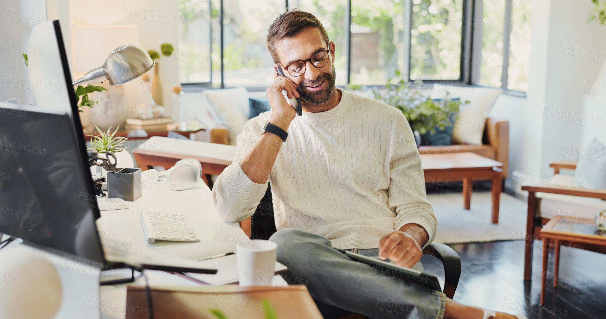 Buy stock photo Phone call, remote work and tablet with man in home office for communication, planning or update. Computer, conversation and research with freelance entrepreneur in apartment for startup development