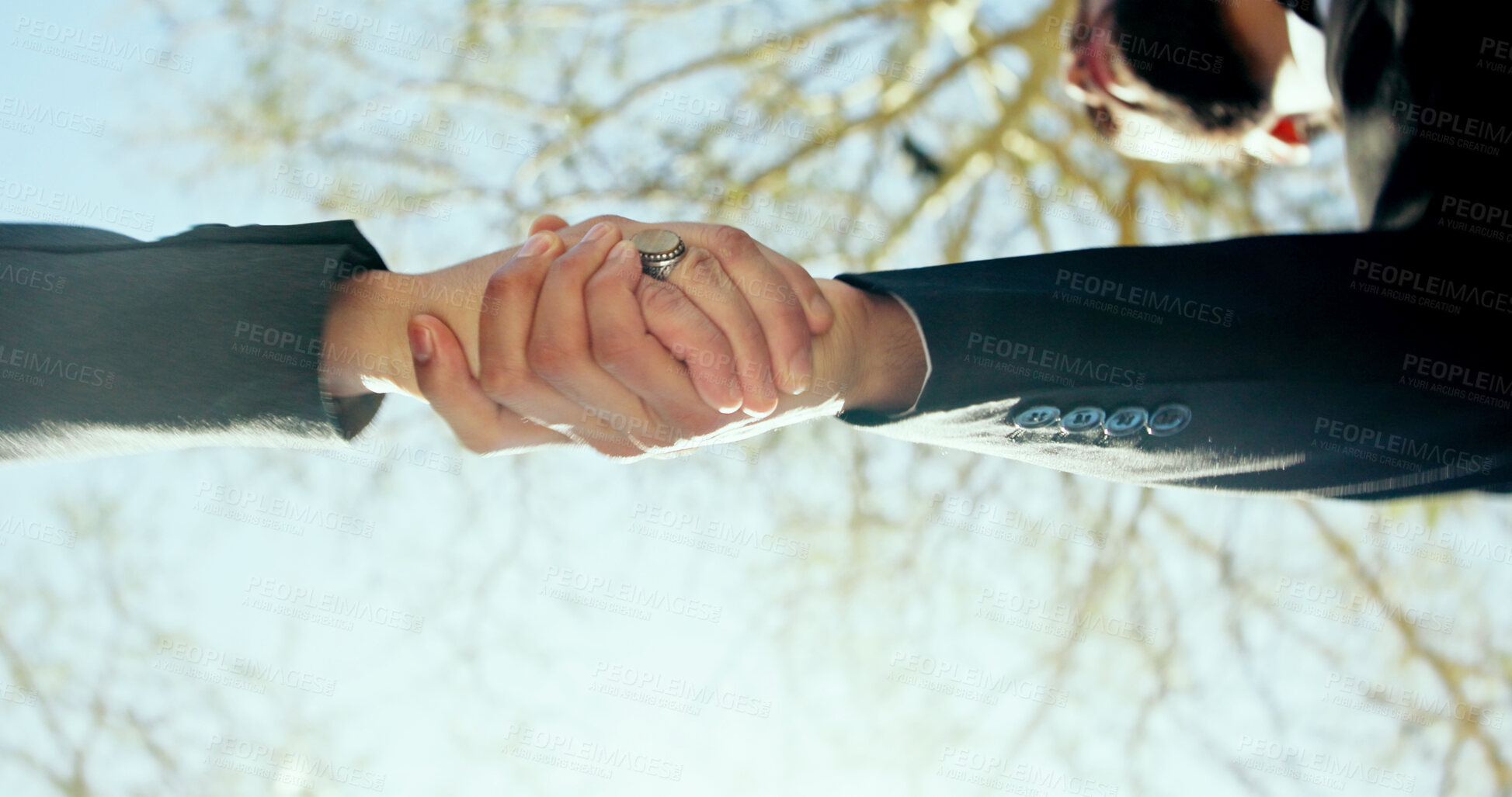 Buy stock photo Shaking hands, outdoor and business people with low angle, agreement and meeting with partner. Handshake, hello and respect with introduction, welcome and thank you for deal in urban park in morning