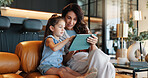 Tablet, elearning and mom with child on sofa for playing educational games with online app. Happy, bonding and mother teaching girl with digital technology for bonding, development or growth in home.