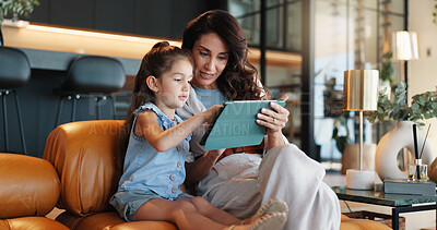 Buy stock photo Tablet, elearning and mom with child on sofa for playing educational games with online app. Happy, connection and mother teaching girl with technology for bonding, development or growth in home.