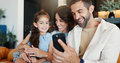 Buy stock photo Parents, child and phone in home for video call, connection and bonding on weekend. Happy family, relax and tech in living room for photography, communication and fun live stream for social media