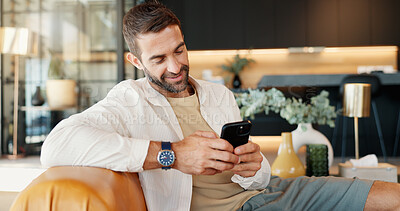 Buy stock photo Home, relax and man on sofa, cellphone and smile with message to contact, email and connection. Person, apartment or guy on couch, smartphone and internet with funny meme, chatting or communication