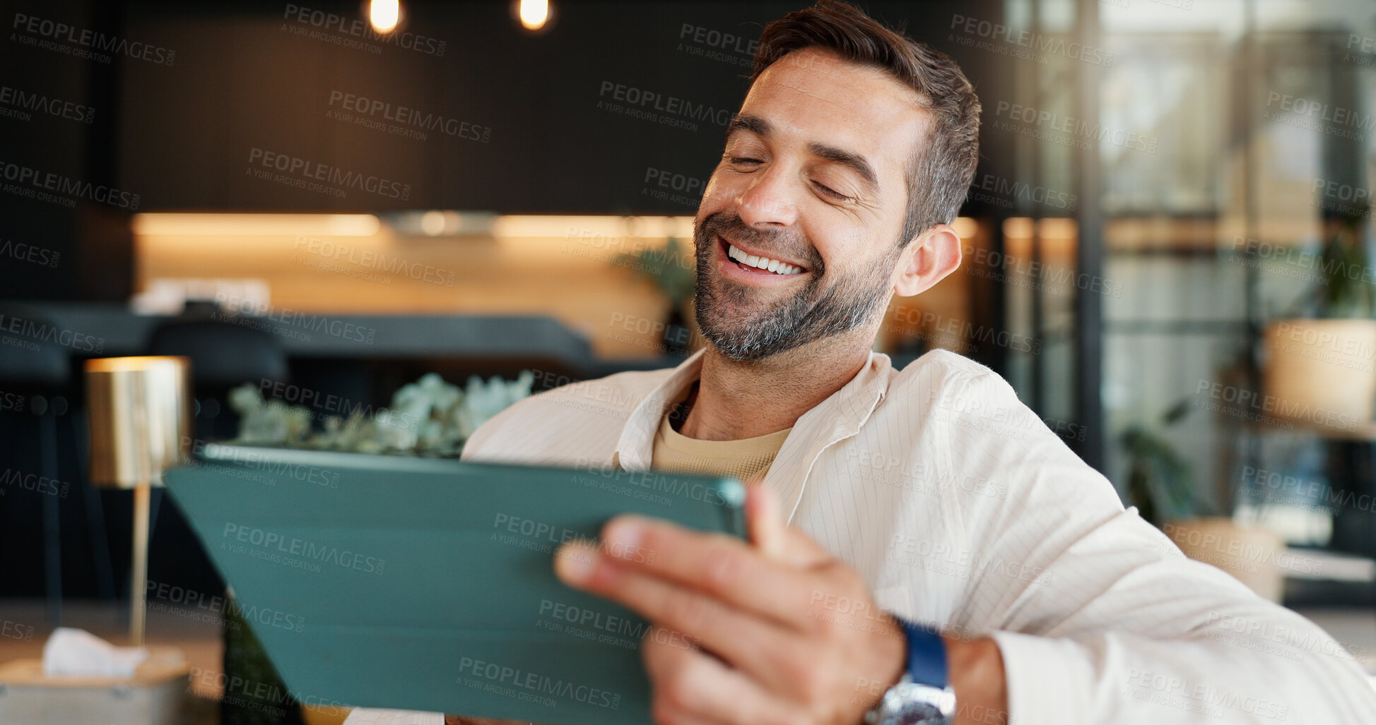 Buy stock photo Laughing, remote work and tablet with man in home for research or small business development. Funny, reading and report with freelance entrepreneur in living room of apartment for startup planning