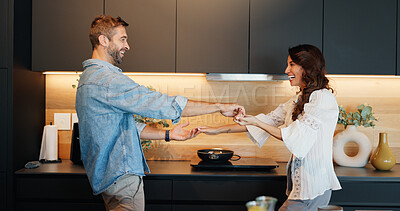 Buy stock photo Mature couple, happy and dancing in kitchen with love, bonding and celebration for anniversary in home. People, man and woman with holding hands, excited or playful rhythm for relationship at house