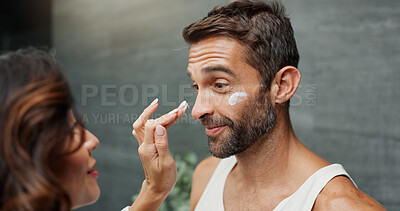 Buy stock photo Skincare, couple and cream on face in bathroom for skin hydration, morning routine or moisturizer. Love, people or happy with product application for sunscreen, dermatology support or bonding in home