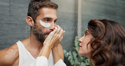 Buy stock photo Beauty, eye mask and help with couple in bathroom of home for antiaging cosmetics or wellness. Application, dermatology and facial product with people in apartment for morning skincare routine