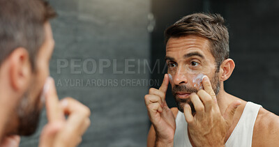 Buy stock photo Skincare, mirror and man with face cream in bathroom for skin hydration, grooming treatment and morning routine. Hygiene, reflection and spf lotion application for moisturizer, wellness or anti aging