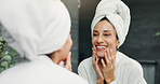Skincare, mirror and woman in bathroom for natural, moisturizing and morning routine in home. Cosmetic, wellness and female person by reflection for facial dermatology treatment for clean in house.