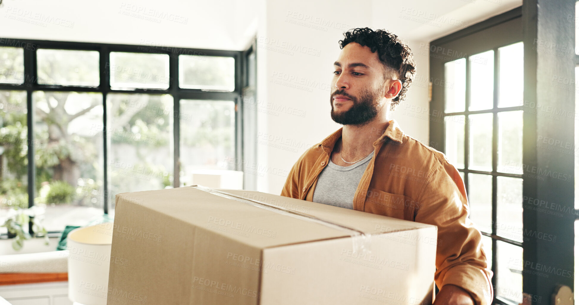 Buy stock photo New house, happy and man with box, real estate and ownership of property with mortgage and lounge. Relocation, buyer and person with cardboard in living room, investment and purchase with home loan
