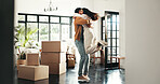 Celebration, hug and couple in new house, real estate and ownership of property with mortgage or lounge. Relocation, happy and people with boxes in living room, investment and purchase with home loan