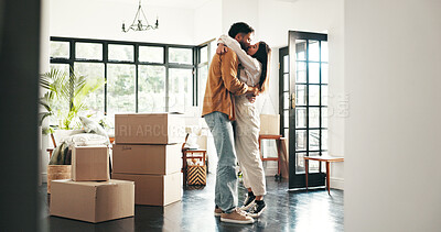 Buy stock photo Celebration, kiss and couple in new house, moving and ownership of property with mortgage or real estate. Relocation, love and people with boxes in living room, investment or hug for purchase of home