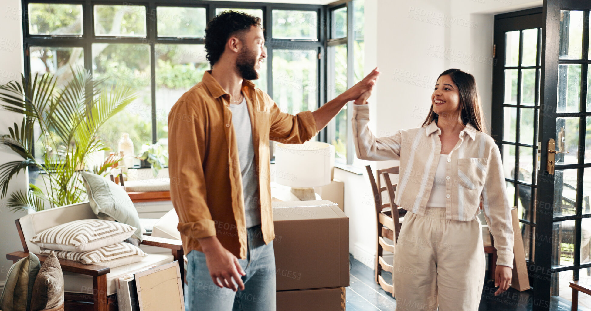 Buy stock photo High five, homeowner and mortgage with couple in living room together for new start or property investment. Boxes, love or success with happy man and woman in apartment for growth or real estate