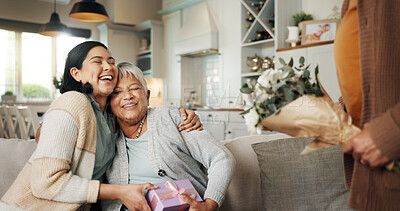 Buy stock photo Birthday, gift or laughing with family on sofa in living room of home together for bonding or celebration. Box, funny or hugging with senior woman and daughter in apartment for event or milestone