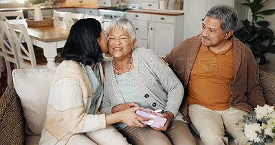 Buy stock photo Birthday, gift or kiss with family on sofa in living room of home together for bonding or celebration. Box, love or present with senior parents and daughter in apartment for event or milestone