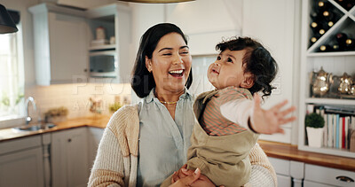 Buy stock photo Home, hug and mom laughing with baby, smile and care for bonding together with love, parent or happiness. Playing, kitchen or mother with growth, joy or infant with development, family or kid for fun