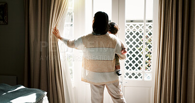 Buy stock photo Mother, child and open curtain in home for new day, morning routine and fresh air. Family, back and woman with window drapes in bedroom for getting ready, sunrise and checking weather in apartment