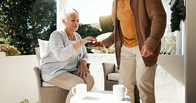 Buy stock photo Porch, senior couple and coffee for breakfast with love, bonding and biscuits in retirement. Patio, old woman and elderly partner with cookies for eating, relationship and outdoor with tea in morning