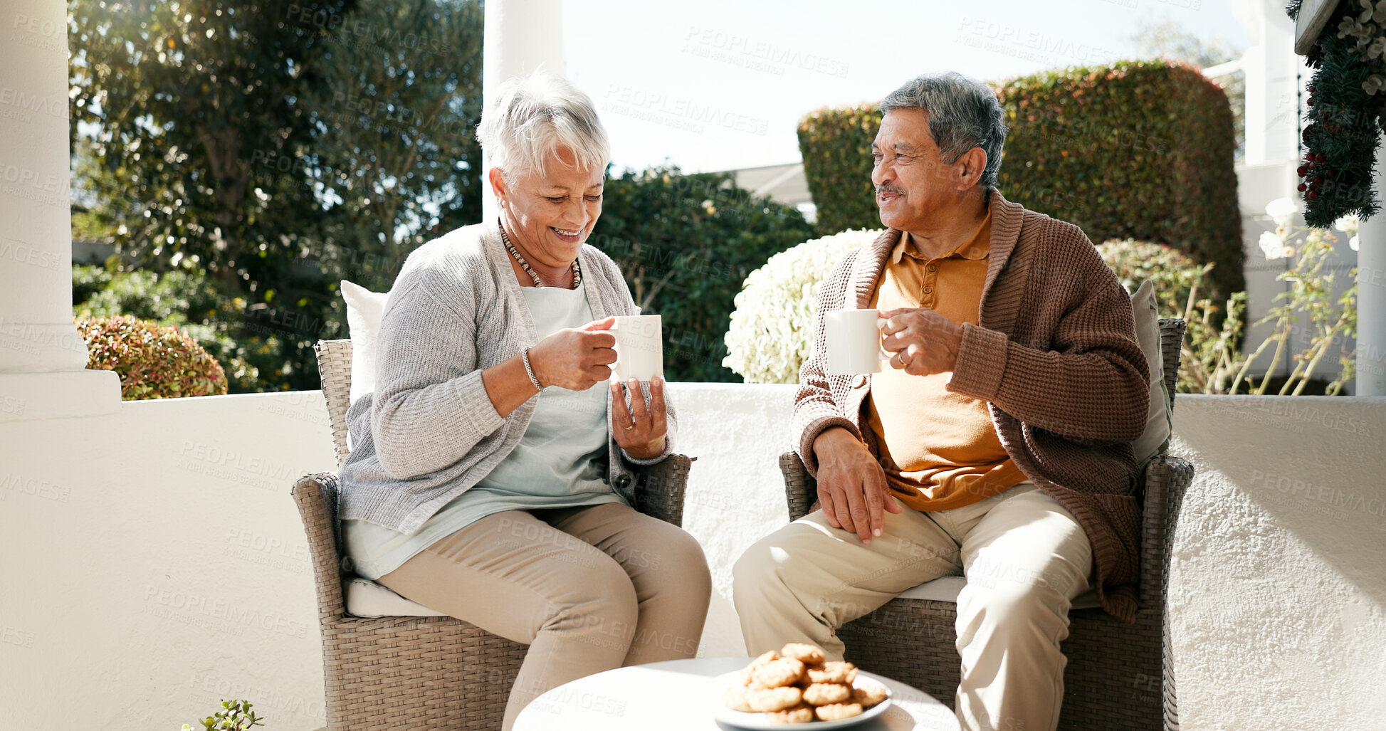Buy stock photo Outdoor, senior couple and talking with coffee for love, bonding or biscuits in retirement. Porch, old woman and elderly man with happiness for relationship, cookies or discussion with tea in morning