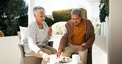 Buy stock photo Outdoor, senior couple and breakfast with coffee for love, bonding or biscuits in retirement. Porch, old woman and elderly man with happiness for relationship, eating and cookies with tea in morning