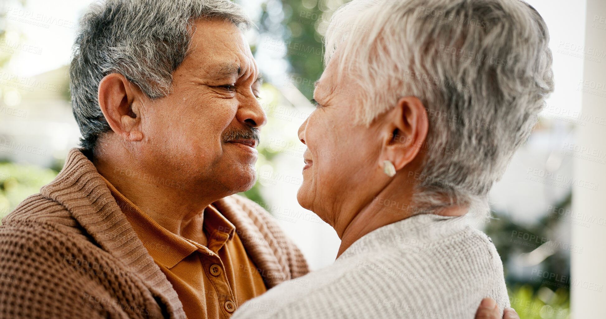 Buy stock photo Senior couple, hug and happy in home, love and bonding with connection, memory and romance on anniversary. Elderly man, woman and embrace with care, relationship and trust with loyalty in retirement
