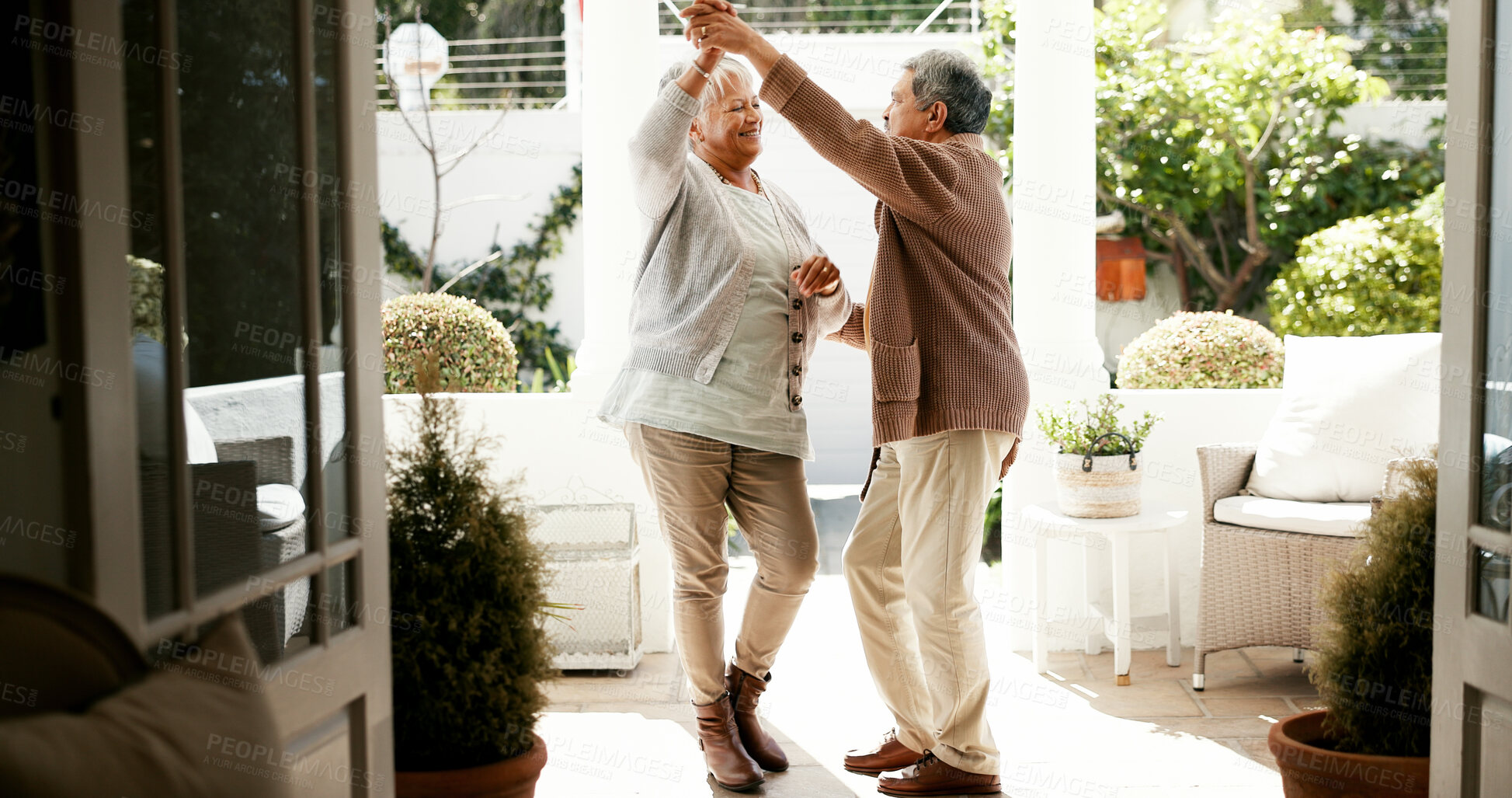 Buy stock photo Mature couple, dancing and spin in home with love, bonding and celebration for anniversary. People, man and woman with holding hands, retirement and smile for twirl, rhythm and relationship at house