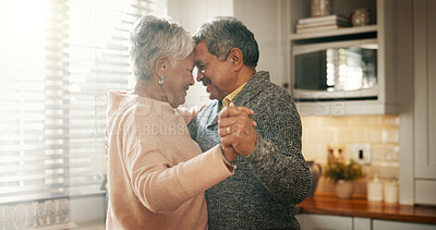 Buy stock photo Senior couple, dancing and happy in kitchen with love, bonding and celebration for anniversary. People, man and woman with holding hands, retirement and smile for memory in relationship at apartment