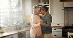 Senior man, woman and dancing in kitchen with love, bonding or celebration for anniversary. Couple, care and connection with holding hands, retirement or happy for memory in relationship at apartment