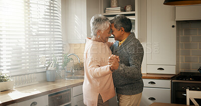 Buy stock photo Senior man, woman and dancing in kitchen with love, bonding or celebration for anniversary. Couple, care and connection with holding hands, retirement or happy for memory in relationship at apartment