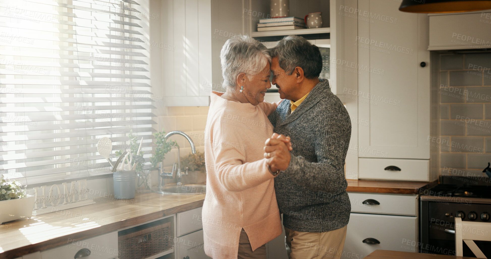 Buy stock photo Senior man, woman and dancing in kitchen with love, bonding or celebration for anniversary. Couple, care and connection with holding hands, retirement or happy for memory in relationship at apartment