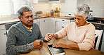 Senior couple, holding hands and bible for prayer in home, eyes closed or faith for worship in retirement. Elderly man, woman and support for religion, book or together with praise, gratitude and God