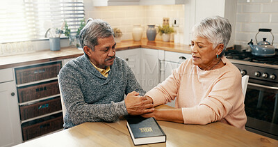 Buy stock photo Senior couple, bible and pray with religion in home, holding hands and faith with worship in retirement. Elderly man, woman and support for peace, book and together with praise, gratitude and God