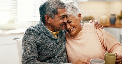Buy stock photo Hug, smile and senior couple with coffee, home and bonding with beverage in kitchen, people and morning. Happy, old man and mature woman with tea in house, comfortable and conversation for family